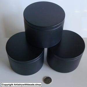 May include: Three black, cylindrical containers with lids are stacked. The containers are made of a matte material. A dime is placed near the containers. The text "Copyright Artistrywithbeads.shop" is at the bottom.