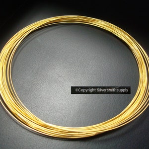 May include: A coil of gold-colored wire.  The wire is wound into a circle and is about 1/4 inch in diameter.  The wire is shiny and smooth.  Copyright Silversmithsupply.