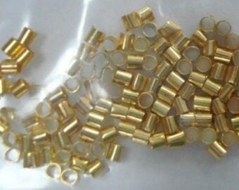 May include: A large quantity of gold-coloured metal jump rings. The rings are small and have a circular opening.