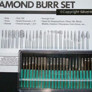 May include: A set of 30 diamond burrs in a clear plastic case with a green label. The burrs are used for shaping stone, glass, tile, wood, marble, ceramic, fiberglass, gold, silver, etc. The burrs are 1 3/4 inches long and have a 1/8 inch shank diameter.