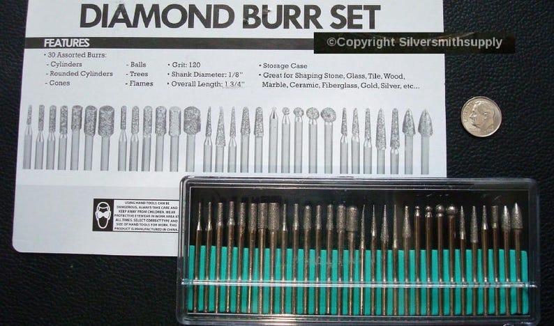 May include: A set of 30 diamond burrs in a clear plastic case with a green label. The burrs are used for shaping stone, glass, tile, wood, marble, ceramic, fiberglass, gold, silver, etc. The burrs are 1 3/4 inches long and have a 1/8 inch shank diameter.