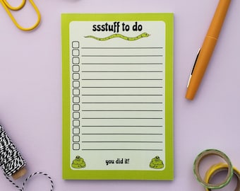 May include: A green notepad with a snake illustration and the text "ssstuff to do". The notepad has a checklist with 15 lines and the text "you did it!" at the bottom.