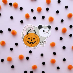 Trick-or-Treat Possum vinyl sticker // possum holding jack-o-lantern bucket // weatherproof