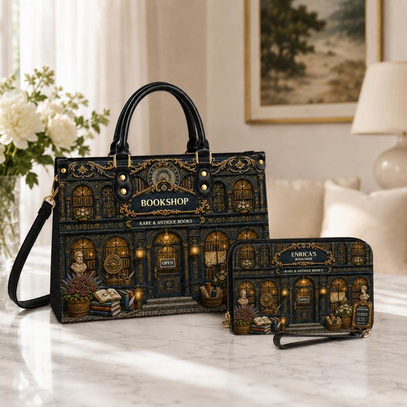 Black bookshop handbag and matching wallet featuring an ornate vintage bookstore facade with arched windows, golden architectural details, books and floral accents. Structured top-handle purse with detachable shoulder strap displayed beside a coordinating zip wallet, ideal for book lovers, readers, librarians and fans of gothic literary accessories and unique bookstore gifts.