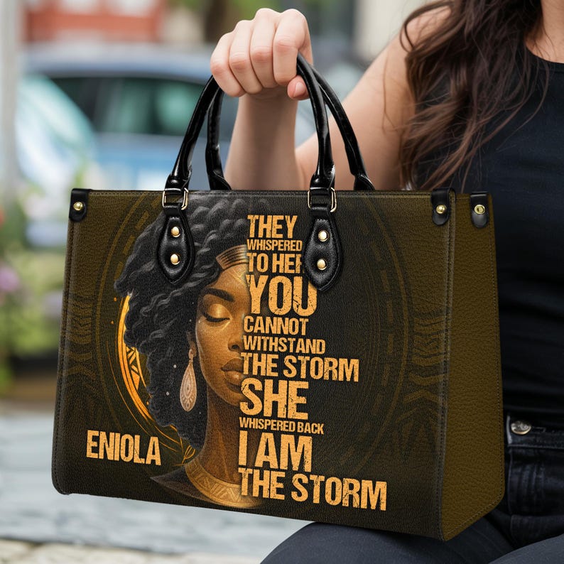 Handheld custom empowerment handbag with Black woman art and quote “I Am The Storm.” Personalized with name for a one-of-a-kind look. Durable faux leather tote, perfect size for daily use. Unique gift for strong women, especially for moms, grandmas, or best friends. Inspirational purse that makes a thoughtful Christmas or birthday present.