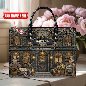 May include: A black handbag with a detailed bookstore facade design. The bag has a black handle and gold embellishments. The bookstore's sign reads "SOPHIA'S BOOKSHOP - RARE & ANTIQUE BOOKS". There is an "ADD NAME HERE" label on the bag.