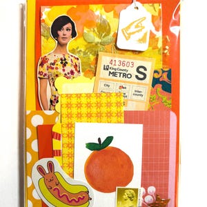 Mystery ephemera pack in Orange and Yellow, showing picture of woman from sewing pattern, vintage texts, decorative papers, art print with orange, vintage paper bus transfer, sheer yellow ribbon with flowers, cancelled postage stamp, and stickers.