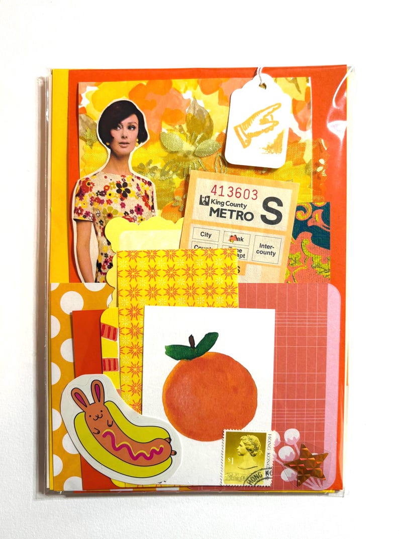 Mystery ephemera pack in Orange and Yellow, showing picture of woman from sewing pattern, vintage texts, decorative papers, art print with orange, vintage paper bus transfer, sheer yellow ribbon with flowers, cancelled postage stamp, and stickers.
