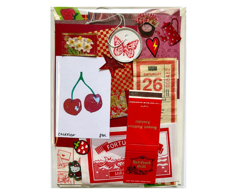 Mystery ephemera pack in Red, showing vintage texts, decorative papers, print with cherries, red matchbook cover, vintage SF muni paper transfer, and stickers.