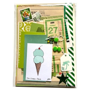 Mystery ephemera pack in Green, showing vintage texts, decorative papers, art print of ice cream cone with two scoops of ice cream (pistachio and mint chocolate chip) with a cherry on top, vintage SF muni paper transfer, cancelled postage stamp, green and white striped ribbon, and stickers.