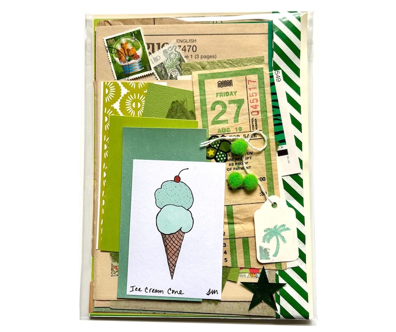 Mystery ephemera pack in Green, showing vintage texts, decorative papers, art print of ice cream cone with two scoops of ice cream (pistachio and mint chocolate chip) with a cherry on top, vintage SF muni paper transfer, cancelled postage stamp, green and white striped ribbon, and stickers.