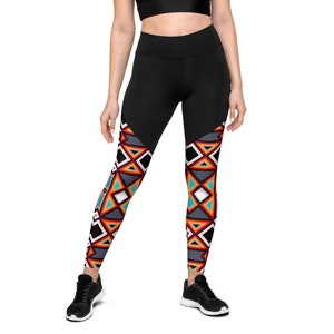 May include: Black leggings with a high waistband and a geometric pattern in shades of gray, red, white, and turquoise. The leggings are form-fitting and suitable for athletic activities.