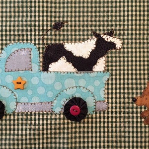 May include: A blue toy truck with a black and white cow in the back. The truck has yellow star and red buttons. A brown dog is running to the right of the truck.