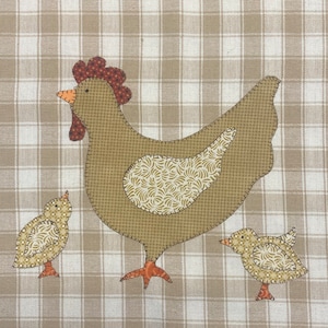 May include: A brown patchwork chicken with a red comb and two smaller brown chicks. The chicken and chicks are on a beige and white checkered background.