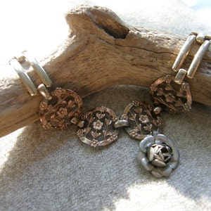 Vintage Assemblage flower theme bracelet in mixed metals with fold over clasp