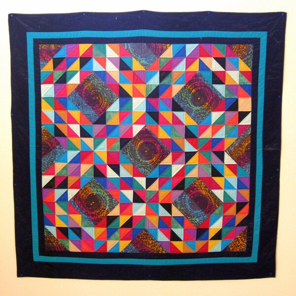 Quilt -- Ocean Waves in Jewel Colors against Blue "Black Hole" Fabric