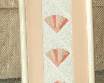 Framed Quilted Wall Hanging -- Four Peach Colored Fans against White Background