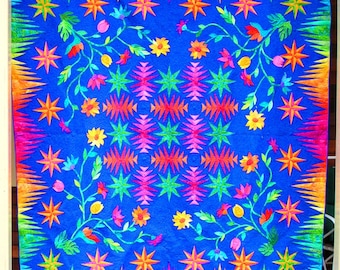 Quilt -- Pineapple Blocks and Appliqued Flowers in Orange, Yellow, Pink, Green and Red are set against a Blue-Purple Background