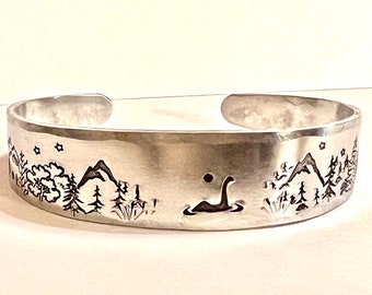 Whimsical Loch Ness Monster hand-stamped tapered aluminum cuff bracelet, Scottish Lore Nessie jewelry