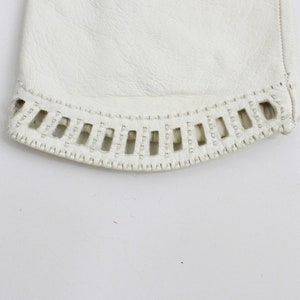 May include: White leather glove with a decorative stitch detail around the cuff.