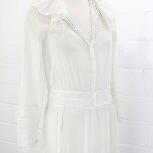 edwardian cotton lawn dress with ruffle collar, loop embroidered trim on sleeves and v neckline, floral embroidered skirt, long sleeves, maxi length, hooks and eyes closure
