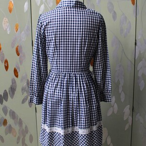 1970s blue white gingham check button up shirt dress with large collar, red and white contrast check patchwork squares and lace border on front, gathered skirt, long sleeves coastal cowgirl