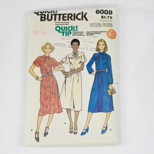 May include: A vintage sewing pattern for a dress, featuring three different styles. The pattern is from Butterick and is number 6008. The dress styles include a floral print, a white dress, and a blue dress.