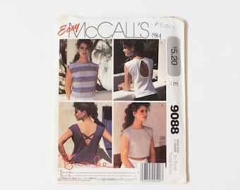 May include: Vintage McCall's sewing pattern from 1984, featuring four images of sleeveless tops. The pattern includes a striped top, a top with a back cutout, a top with crisscross straps, and a cropped top. The pattern number is 9088.