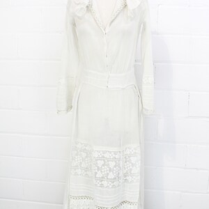 edwardian cotton lawn dress with ruffle collar, loop embroidered trim on sleeves and v neckline, floral embroidered skirt, long sleeves, maxi length, hooks and eyes closure  antique bridal dress