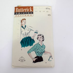 May include: Vintage sewing pattern for a blouse with a collar and long sleeves. The pattern is from Butterick and is printed on a white background with a black and brown border. The pattern number is 6732 and the price is 45 pence.