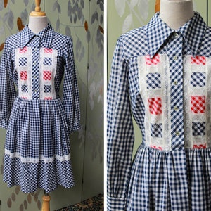 1970s blue white gingham check button up shirt dress with large collar, red and white contrast check patchwork squares and lace border on front, gathered skirt, long sleeves coastal cowgirl
