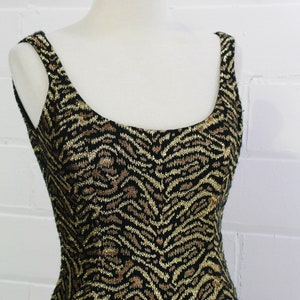 May include: A sleeveless dress with a black and gold zebra print pattern.