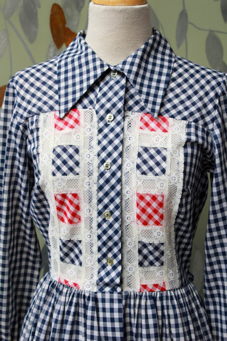 1970s blue white gingham check button up shirt dress with large collar, red and white contrast check patchwork squares and lace border on front, gathered skirt, long sleeves coastal cowgirl