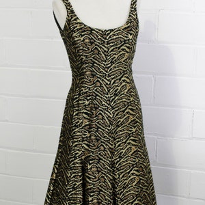 May include: A black and gold sleeveless dress with a tiger print pattern.