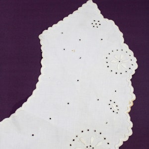 May include: White cotton lace collar with scalloped edges and delicate embroidered floral designs.