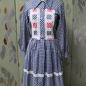 1970s blue white gingham check button up shirt dress with large collar, red and white contrast check patchwork squares and lace border on front, gathered skirt, long sleeves coastal cowgirl