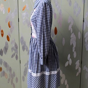 1970s blue white gingham check button up shirt dress with large collar, red and white contrast check patchwork squares and lace border on front, gathered skirt, long sleeves coastal cowgirl