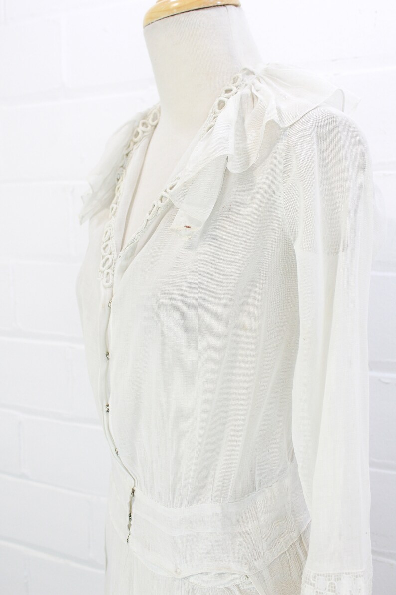 edwardian cotton lawn dress with ruffle collar, loop embroidered trim on sleeves and v neckline, floral embroidered skirt, long sleeves, maxi length, hooks and eyes closure  antique bridal dress