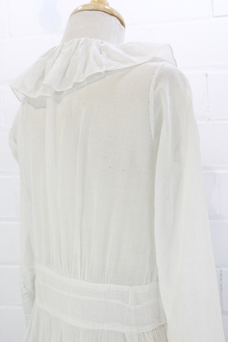 edwardian cotton lawn dress with ruffle collar, loop embroidered trim on sleeves and v neckline, floral embroidered skirt, long sleeves, maxi length, hooks and eyes closure  antique bridal dress