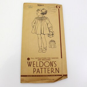 May include: A vintage sewing pattern for a girl's dress. The pattern is for a dress with a gathered neckline and puffed sleeves. The pattern is from Weldon's Pattern and is for sizes 7 and 8 years. The pattern is printed on brown paper and has a price of 6 pence.