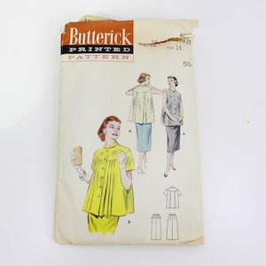 May include: Vintage sewing pattern for a women's blouse and skirt. The pattern is from Butterick and is printed on a white background with a yellow, orange, and brown border. The pattern shows two women wearing the blouse and skirt, one with a yellow blouse and the other with a grey blouse. The pattern number is 6517.