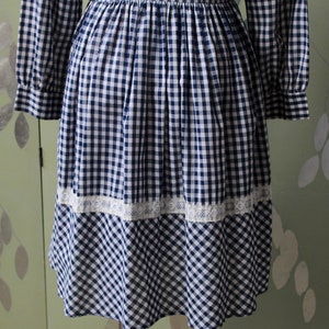 1970s blue white gingham check button up shirt dress with large collar, red and white contrast check patchwork squares and lace border on front, gathered skirt, long sleeves coastal cowgirl