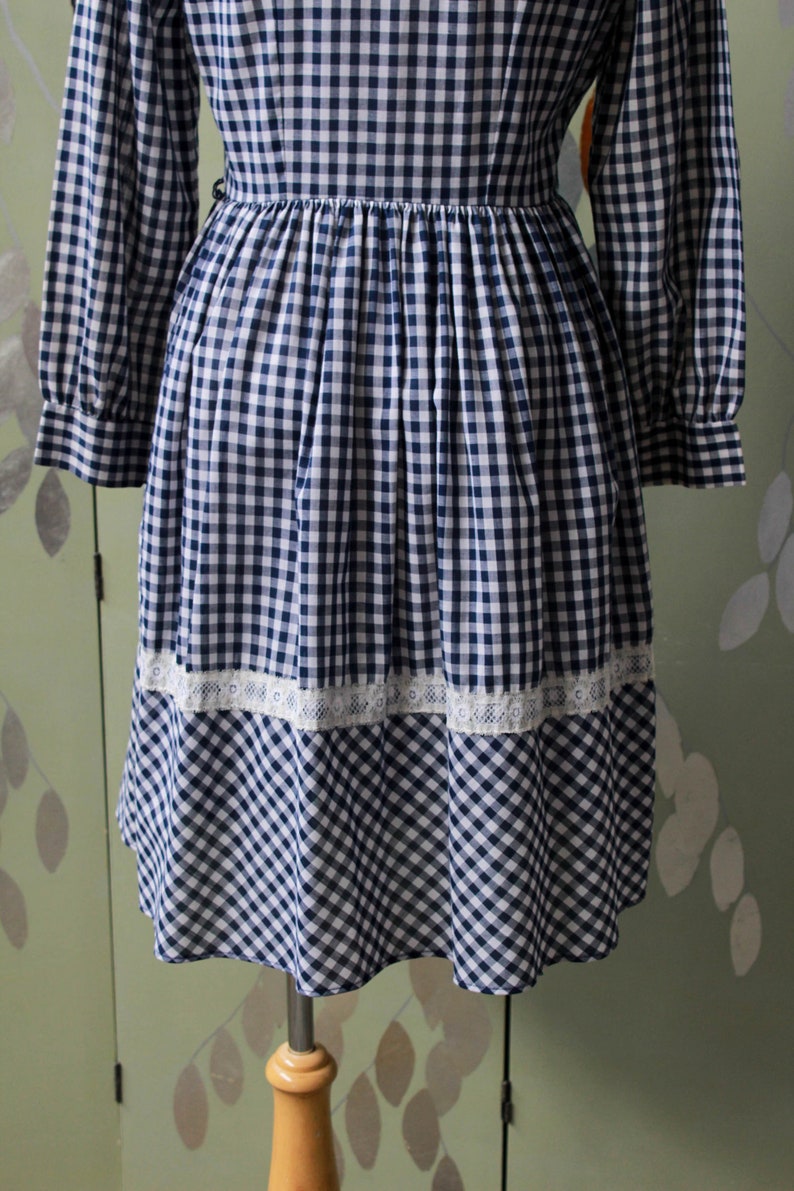 1970s blue white gingham check button up shirt dress with large collar, red and white contrast check patchwork squares and lace border on front, gathered skirt, long sleeves coastal cowgirl