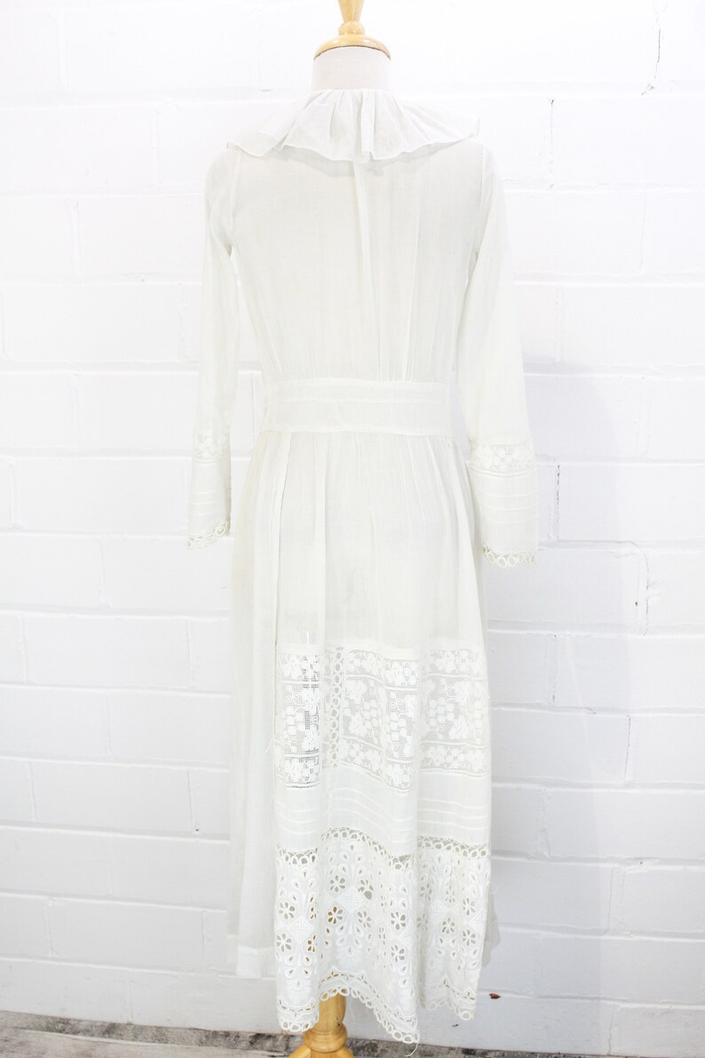 edwardian cotton lawn dress with ruffle collar, loop embroidered trim on sleeves and v neckline, floral embroidered skirt, long sleeves, maxi length, hooks and eyes closure  antique bridal dress
