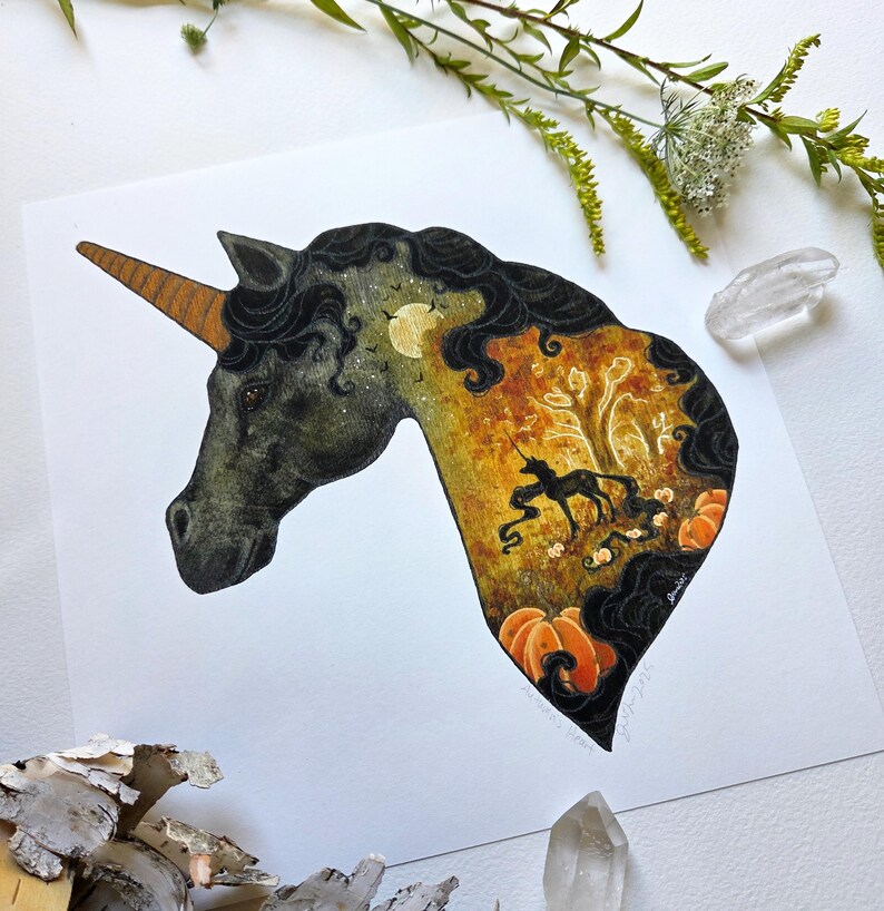 May include: A whimsical illustration of a unicorn's head, featuring a detailed interior scene. The artwork showcases a black unicorn silhouette within a fall-themed landscape with pumpkins, trees, and a full moon. The unicorn has a brown horn and black mane.