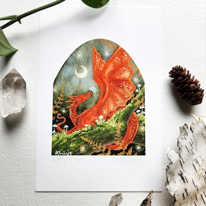 May include: A red dragon with gold accents is perched on a branch in a woodland setting. The dragon is looking up at a small white flower. The background is a dark blue with stars and a crescent moon.