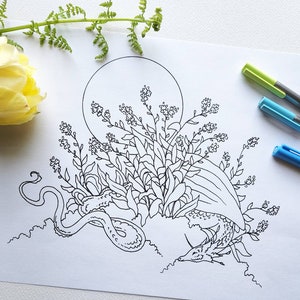 Puede incluir: Un dibujo en blanco y negro de un drag&oacute;n enroscado en un lecho de flores. El drag&oacute;n est&aacute; rodeado de una luna llena y flores.