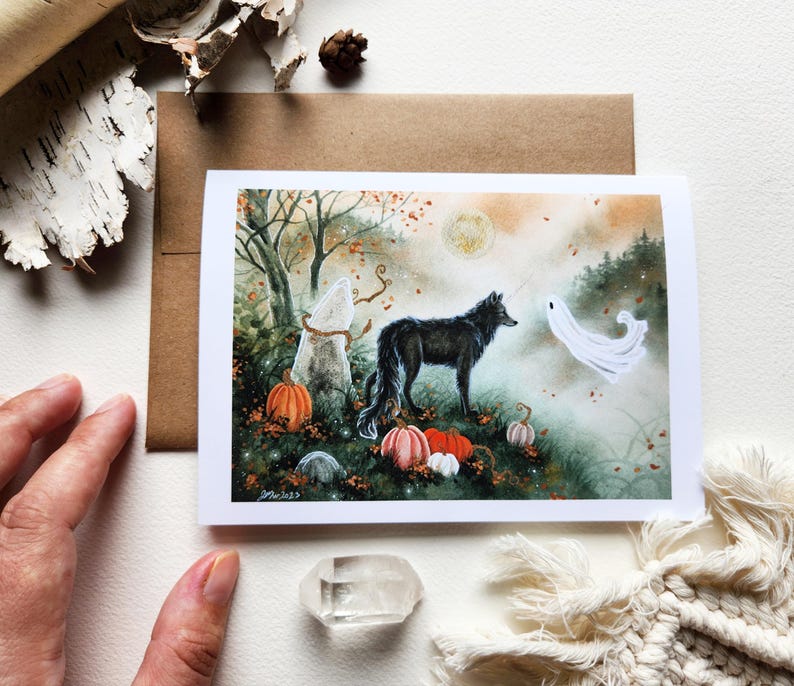 May include: A watercolor illustration of a black wolf standing in a forest with a white ghost and pumpkins. The scene is set in a foggy forest with fall leaves and a full moon in the background.