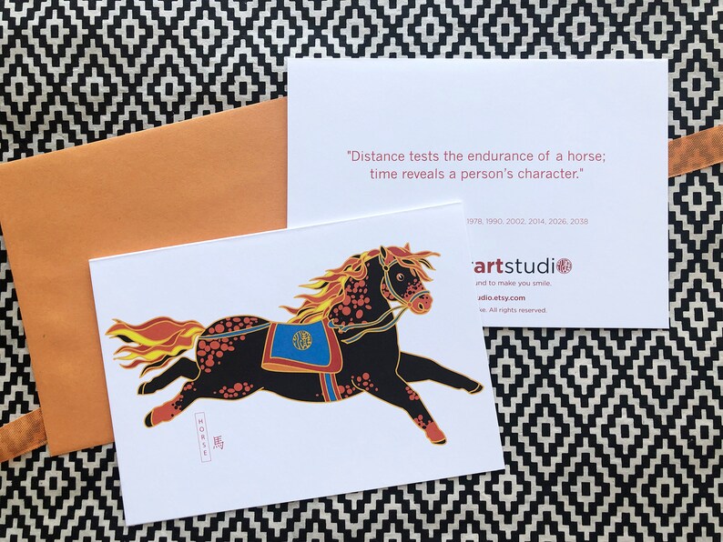 May include: A black and orange horse with a yellow mane and tail, running to the right. The horse is wearing a blue and gold saddle. The image is on a white background with the text "HORSE" and a Chinese character for "horse" in red ink. The text "Distance tests the endurance of a horse; time reveals a person's character." is on the back of the card. The text "artstudio" and "adio.etsy.com" are also on the back of the card.