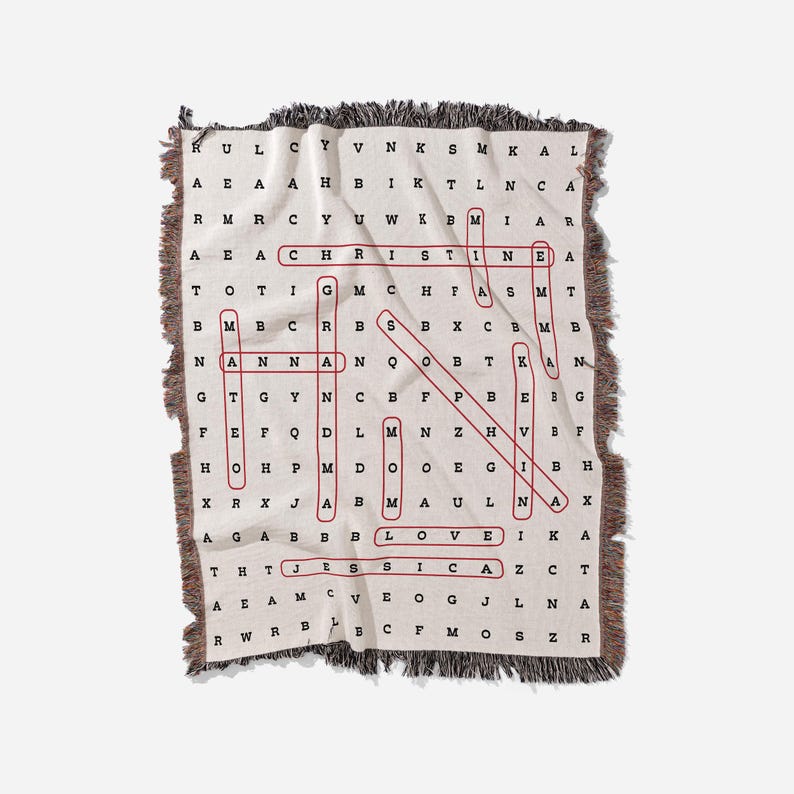 May include: A beige woven throw blanket with a red word search puzzle featuring the words "CHRISTIAN", "LOVE", and "JESUS".